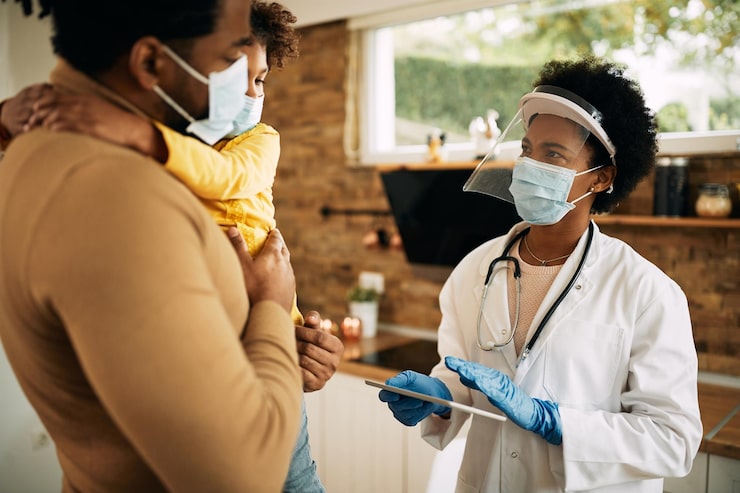 african-american-family-doctor-communicating-with-father-daughter-home-visit_637285-10508